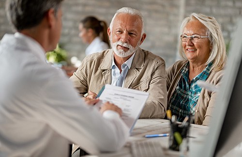 Senior couple filling out paperwork