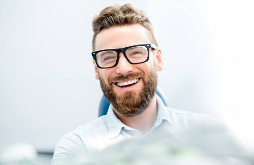 man smiling after getting dental implants