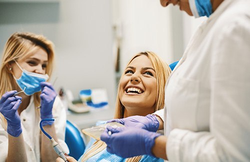 woman smiling while visiting dentist