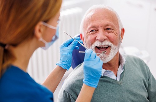 Mature man smiling during dental checkup 