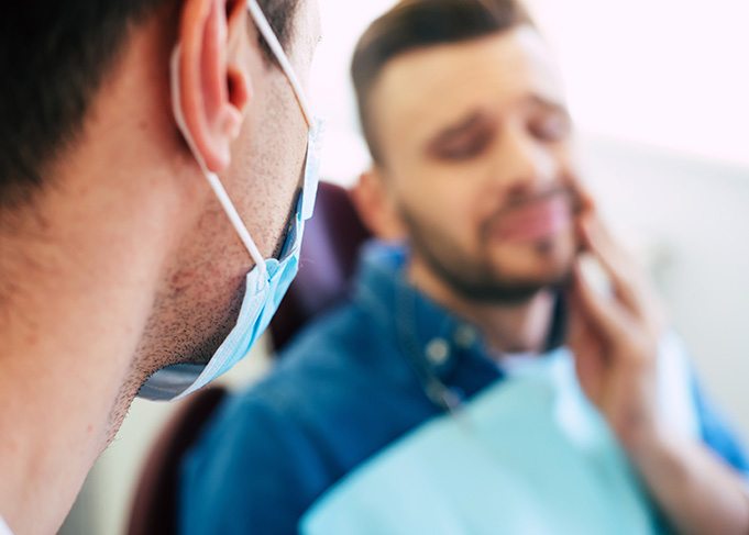 Dentist talking to patient with toothache