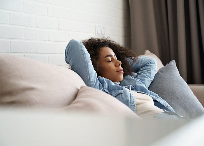 Woman relaxing on couch at home